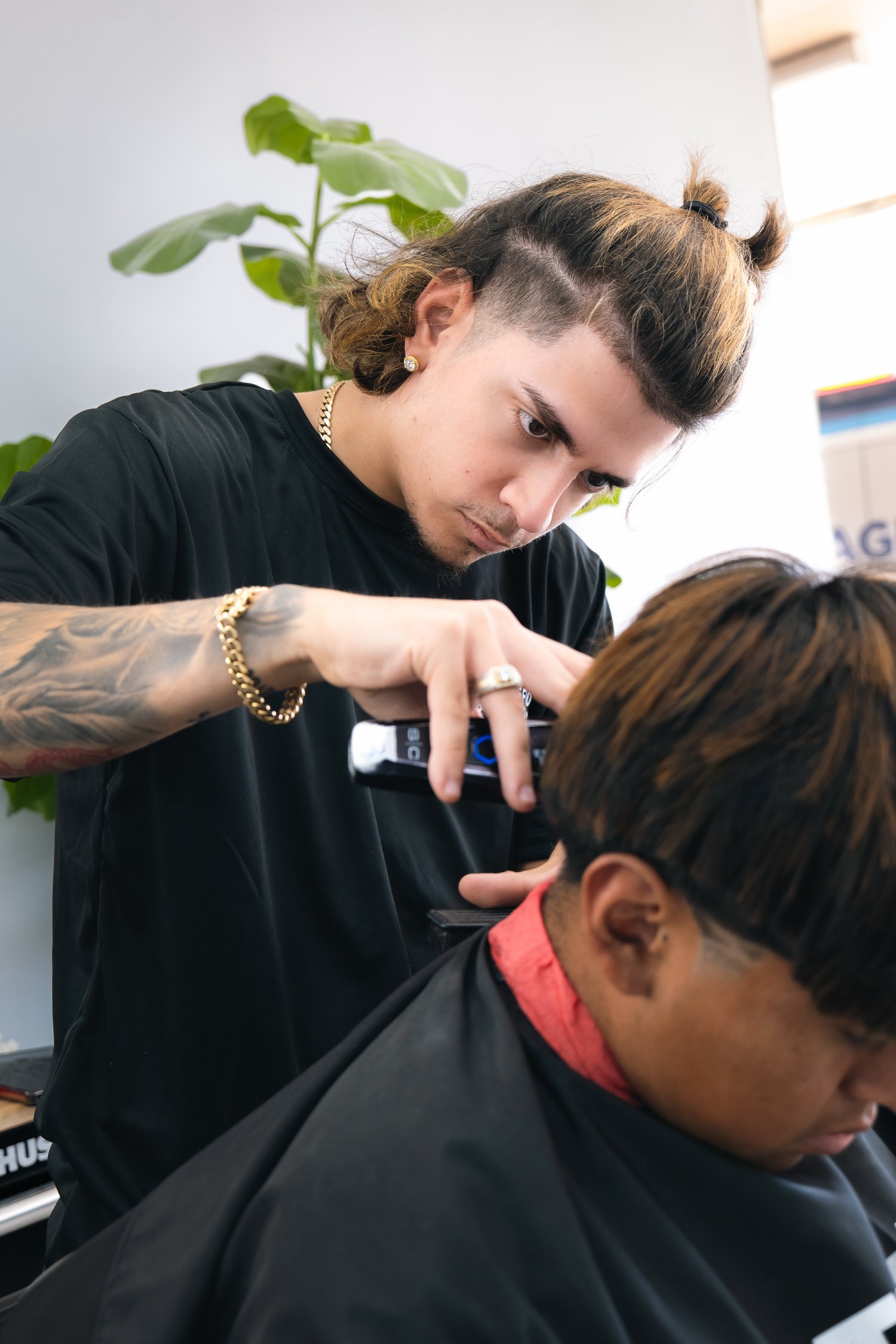 Barber giving a detailed haircut at Elite Fade Lounge