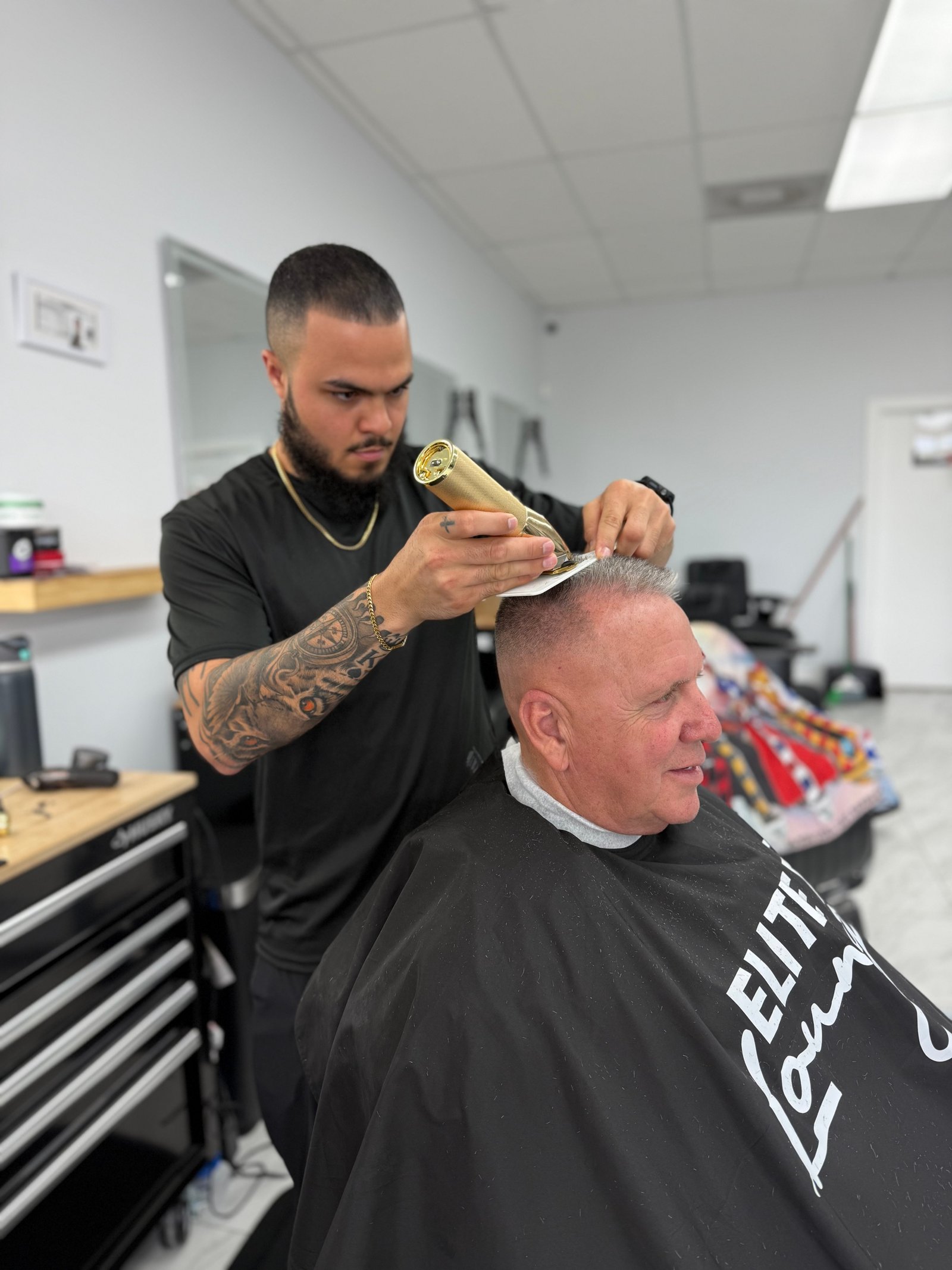 Barber at work inside Elite Fade Lounge