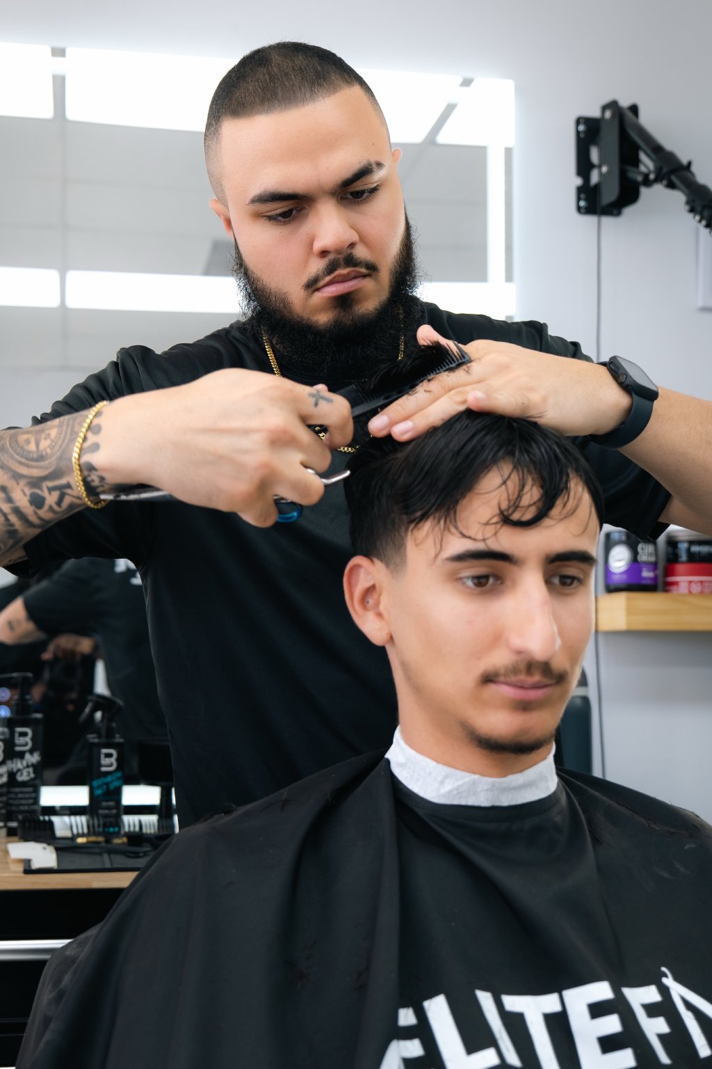 Barber giving a precision haircut at Elite Fade Lounge