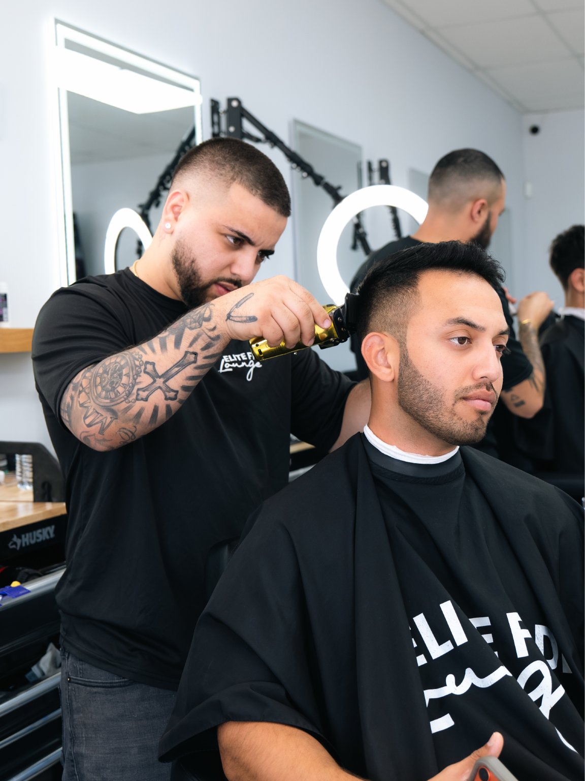 Barber giving a precision haircut at Elite Fade Lounge
